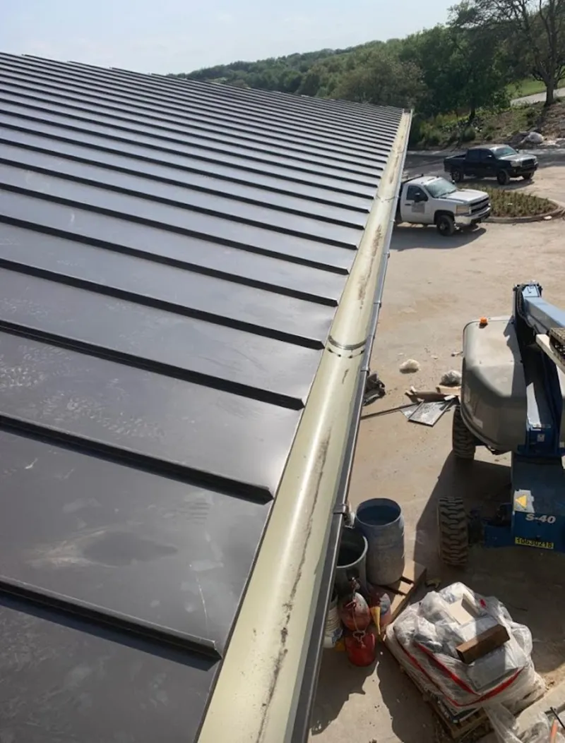 Standing seam panel and gutter detail on a metal roofing jobsite in Gloucester Point